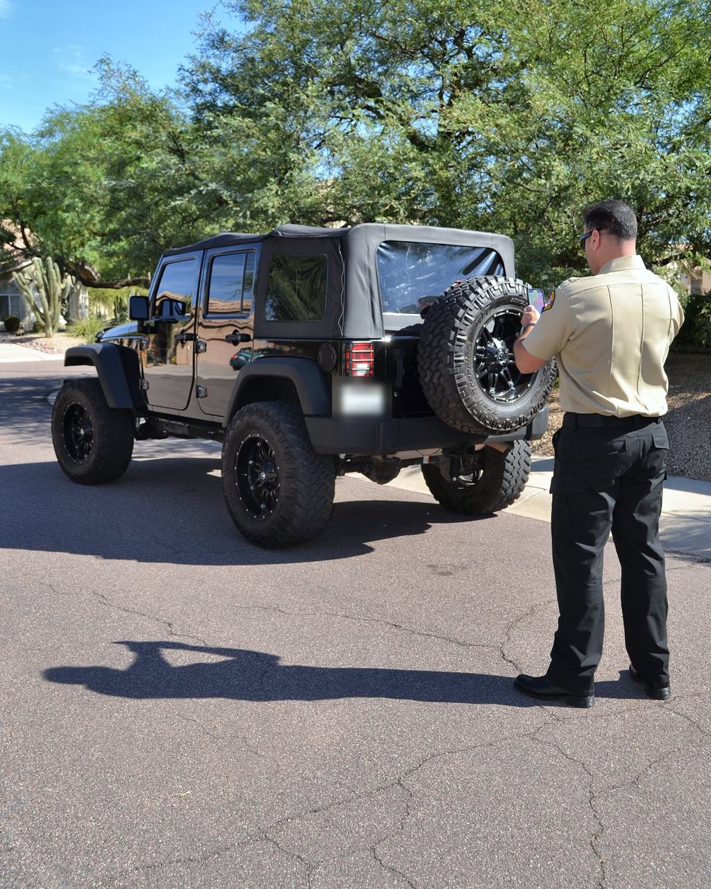 SecureOne security officer checking a parked vehicle
